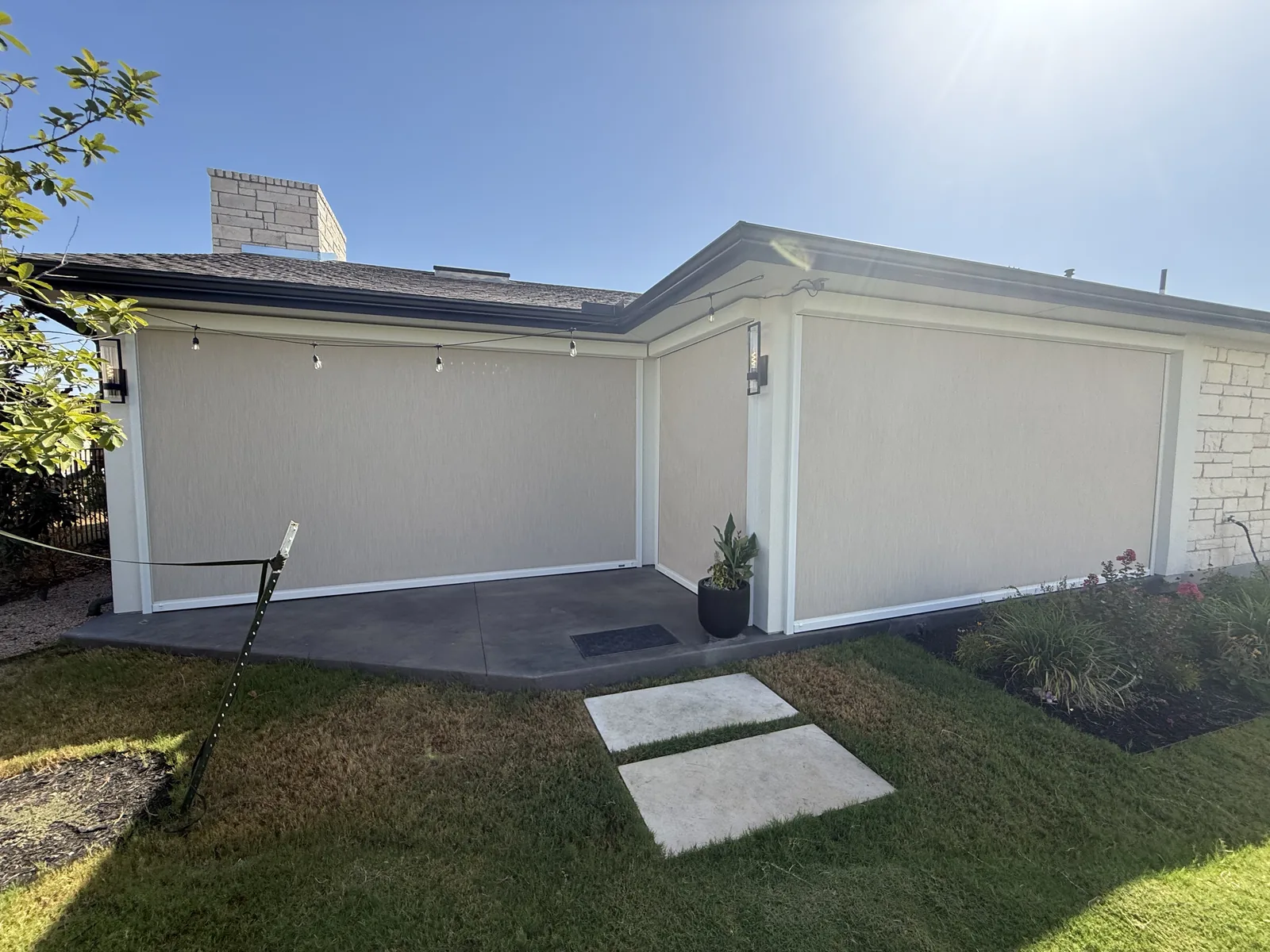 Exterior view of the Rough Hollow covered patio with MagnaTrack screens lowered