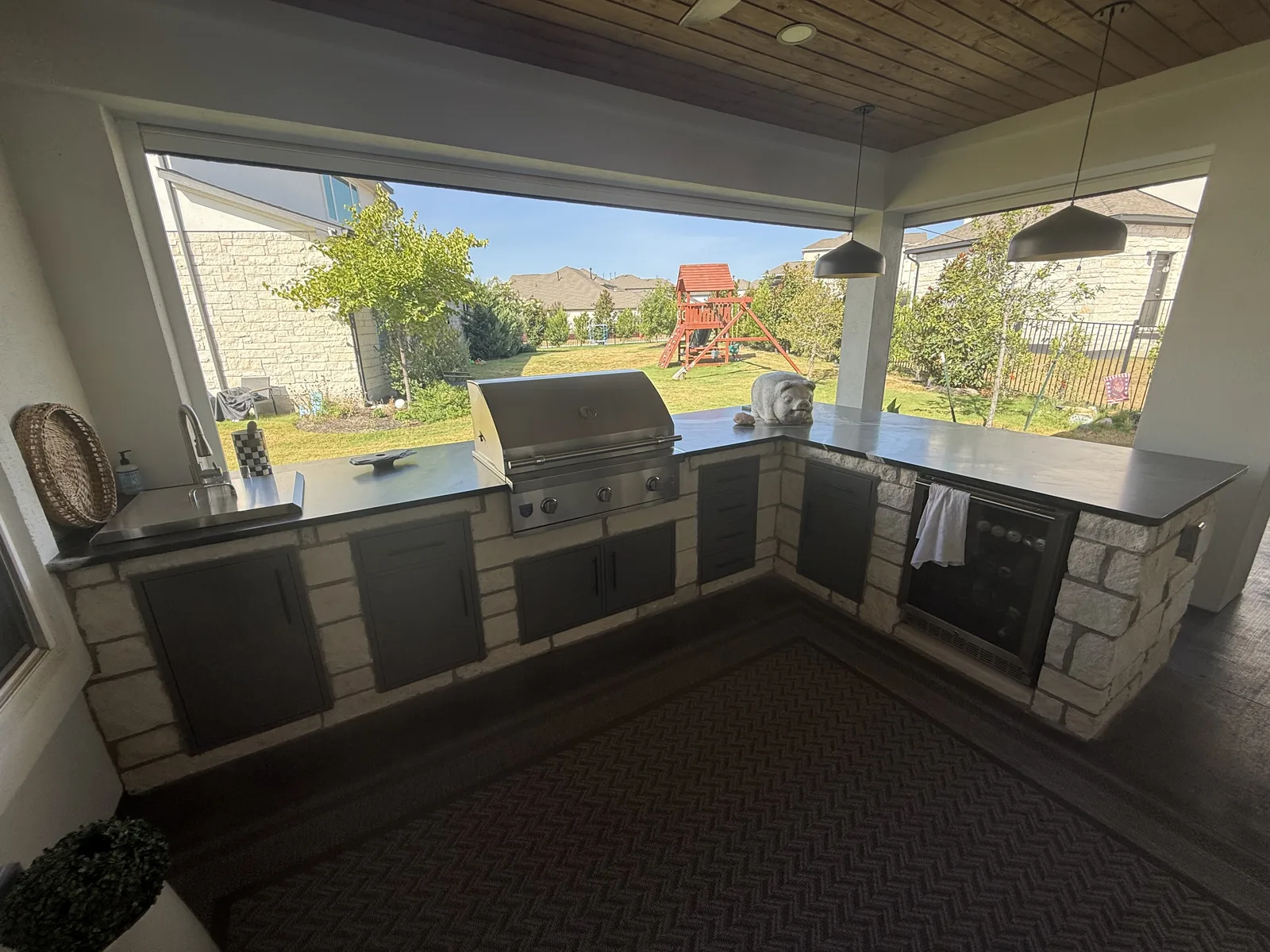 Built-in cooking counter with grill and appliances at the Rough Hollow project