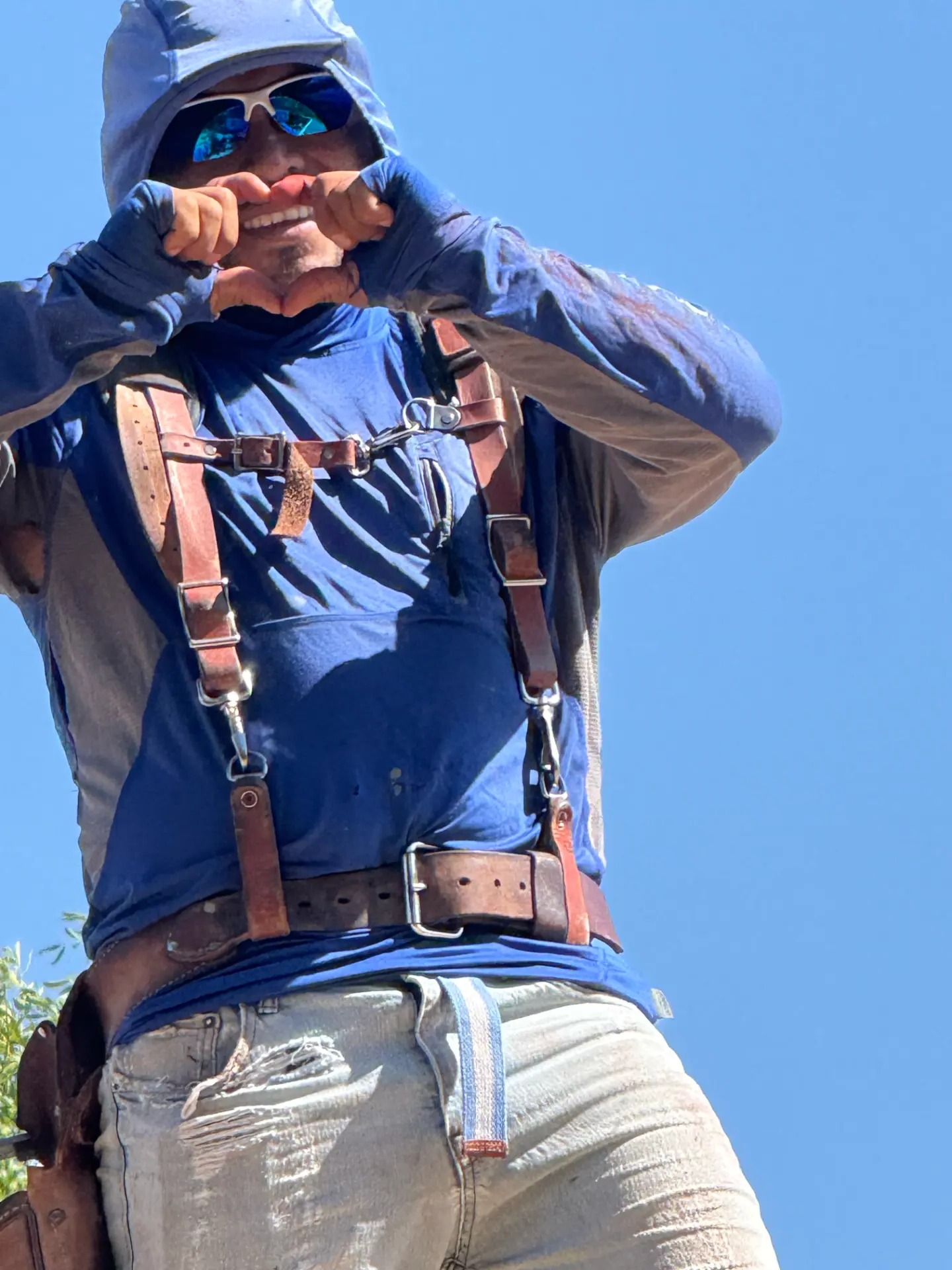 TWT crew member in safety harness working on a roofing or exterior project