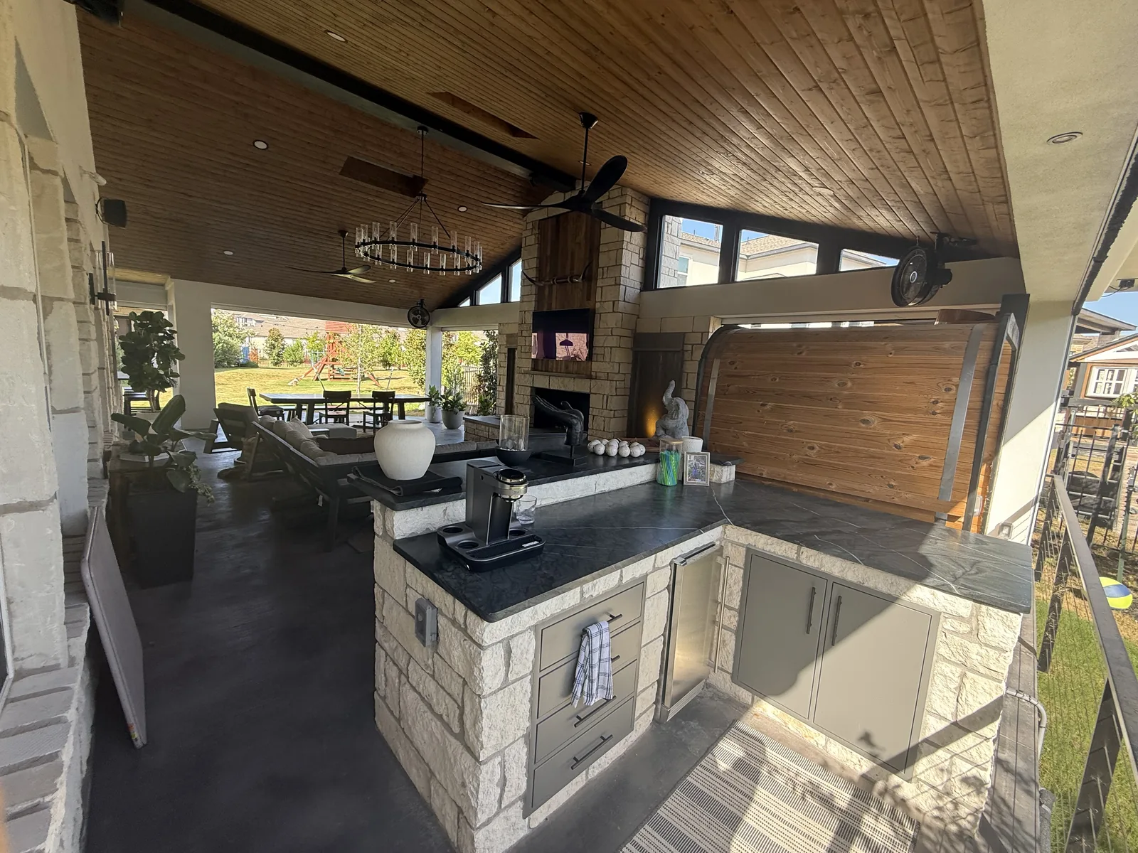 Completed covered outdoor kitchen with counters and serving space at the Rough Hollow project