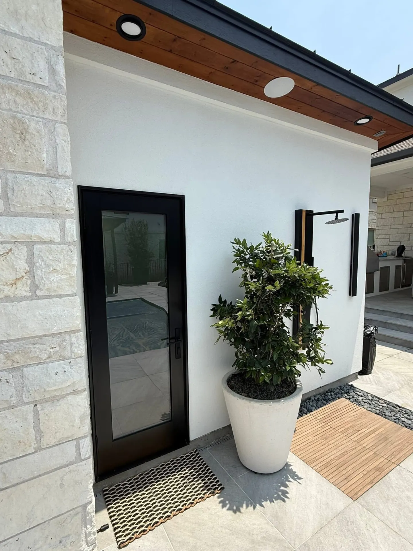 Detached custom structure sited on a finished property with matching exterior materials