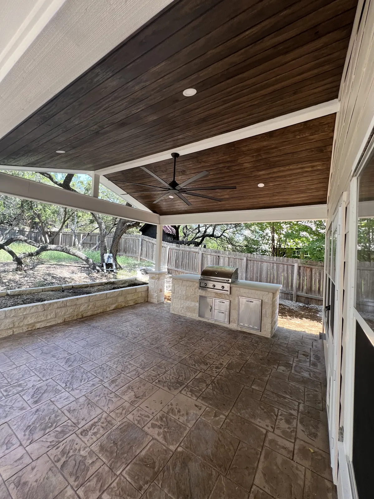 Covered patio with stained decorative concrete and a built-in grill counter