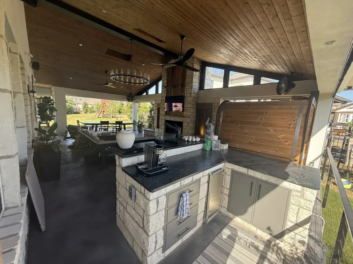 Completed covered outdoor kitchen with counters and serving space at the Rough Hollow project