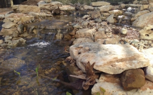 Newly placed landscaping rocks with water flowing