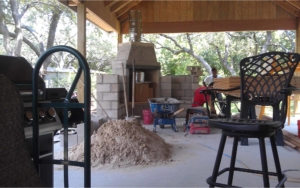 View of a fireplace being built in a covered patio