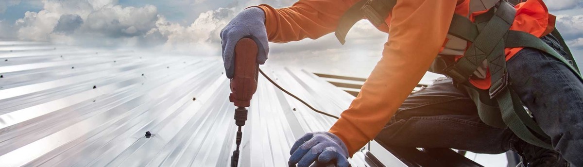 A worker is drilling the roof to inspect the house roof quality in Austin, TX