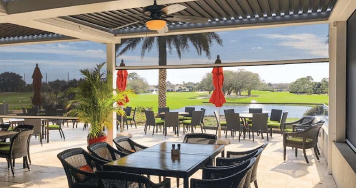 Restaurant with a gold course view and motorized commercial Magna track screen in Austin, TX