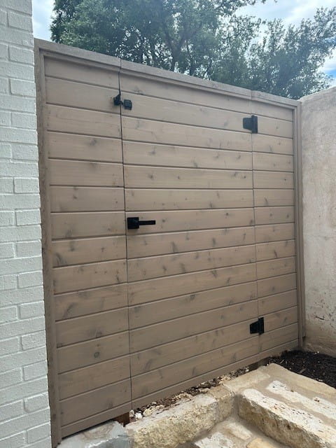 Exterior showcase in Austin, TX, featuring a wood privacy gate with modern hardware