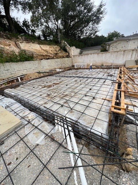 Concrete foundation with rebar grid and framing forms for exterior construction in Austin, TX