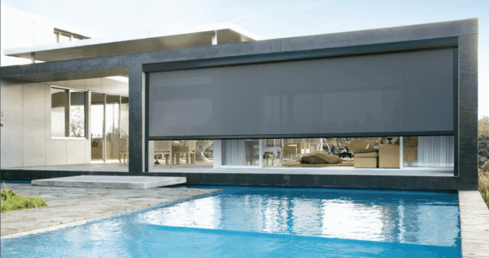 Modern Austin home exterior with pool and large MagnaTrack screen enclosure system